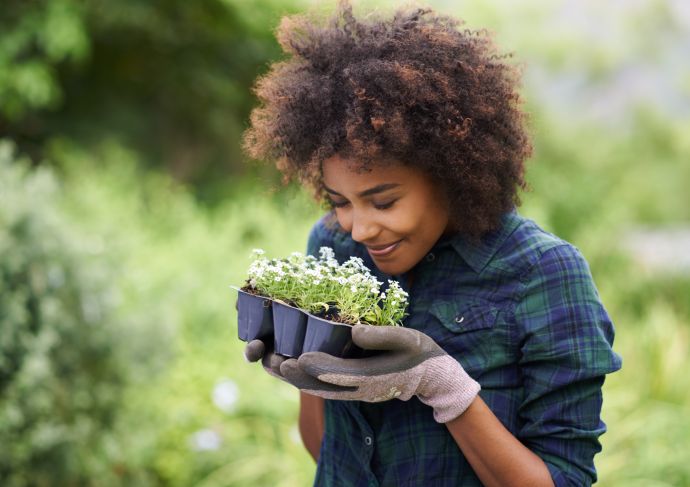 Woman smelling plants in garden