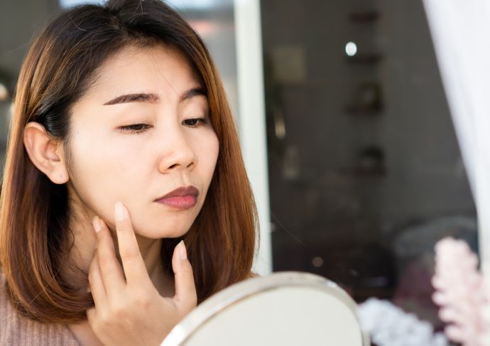 Dermal fillers covid 19 vaccine woman looking in mirror