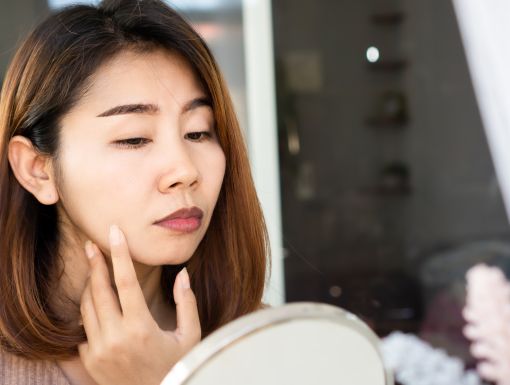 Dermal fillers covid 19 vaccine woman looking in mirror