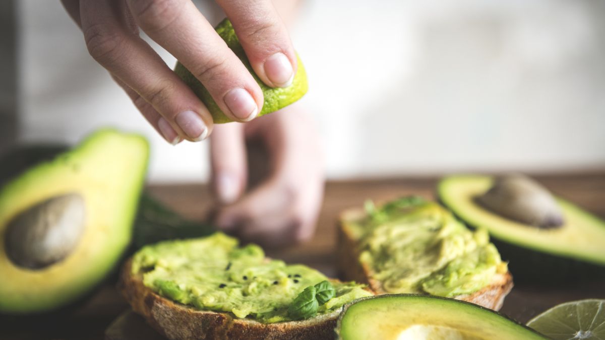 Woman making avocado toast