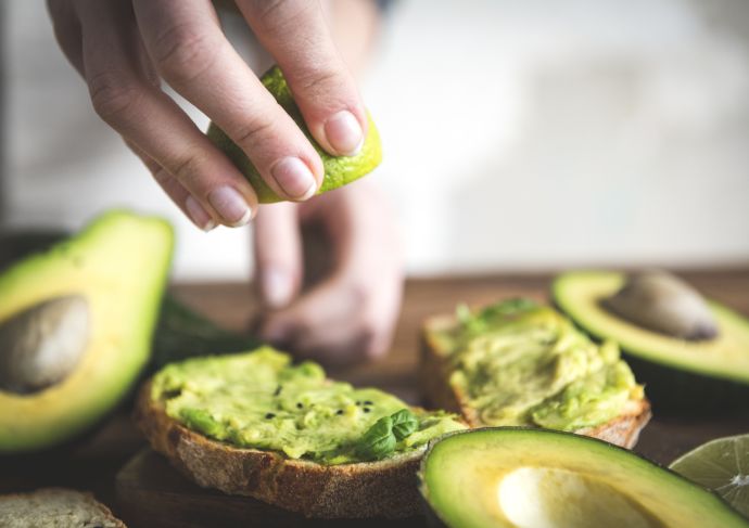Woman making avocado toast