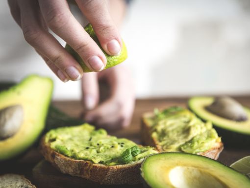 Woman making avocado toast