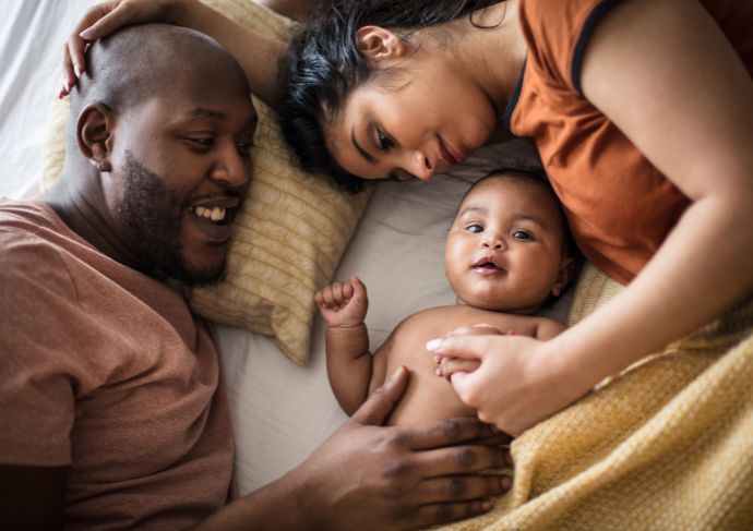Parents laying with baby