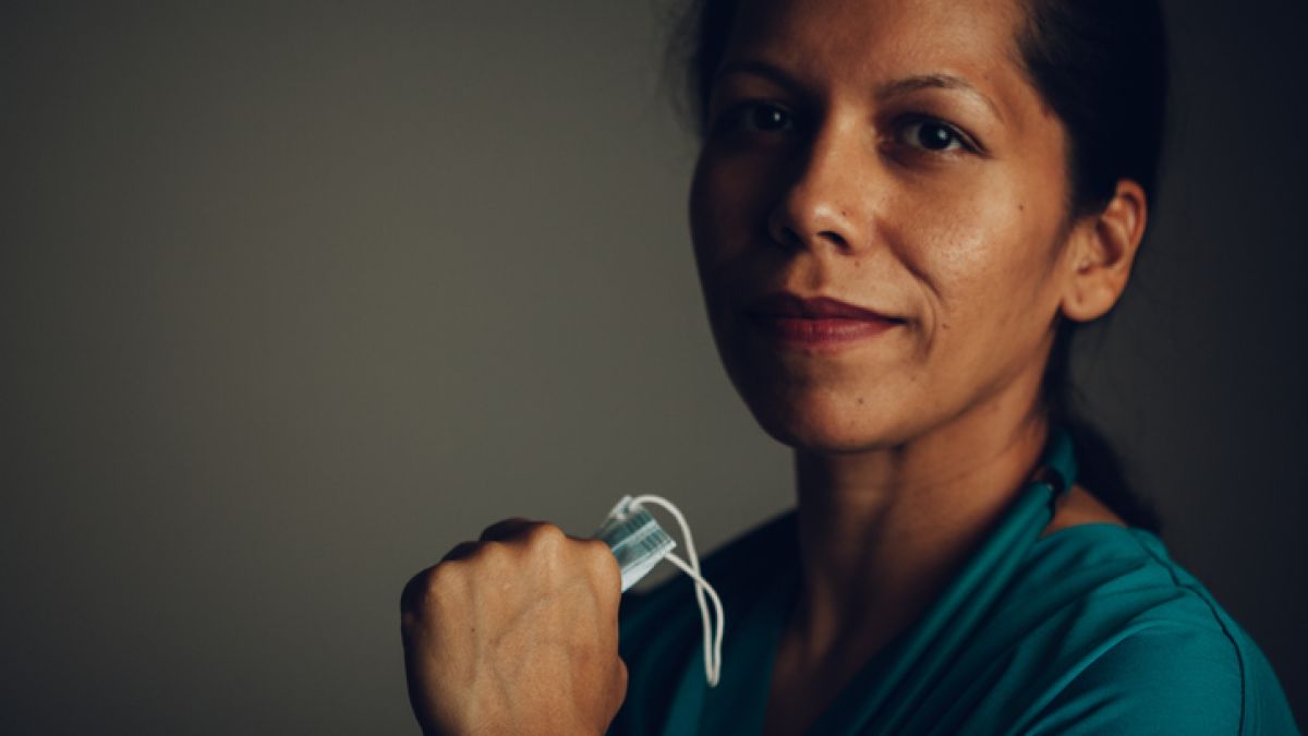 a colorectal surgeon holding a surgical mask