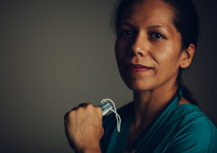 a colorectal surgeon holding a surgical mask
