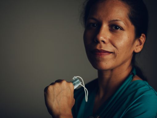 a colorectal surgeon holding a surgical mask