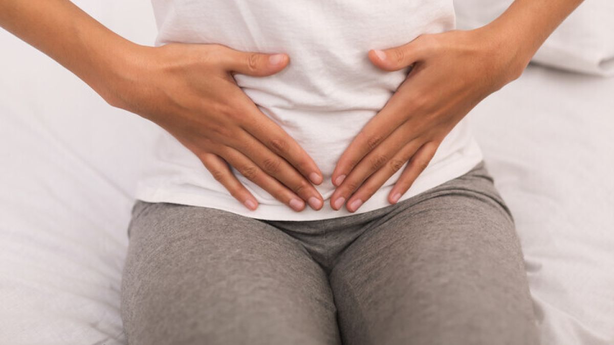 Woman holding lower abdomen