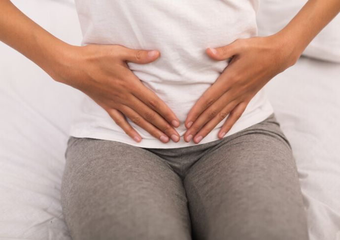 Woman holding lower abdomen