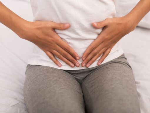 Woman holding lower abdomen
