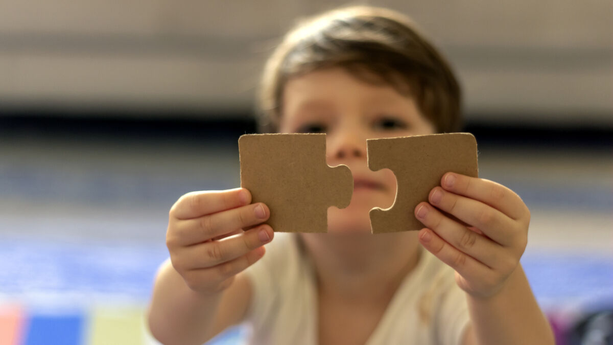 Boy with puzzle pieces autism