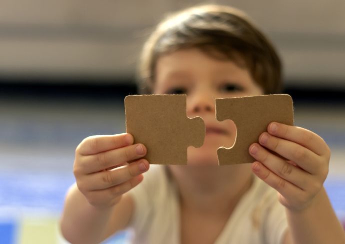 Boy with puzzle pieces autism