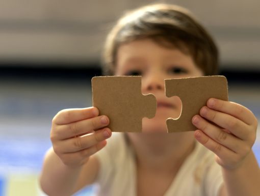 Boy with puzzle pieces autism
