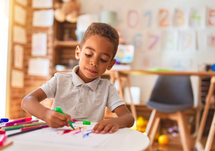 Boy drawing at table