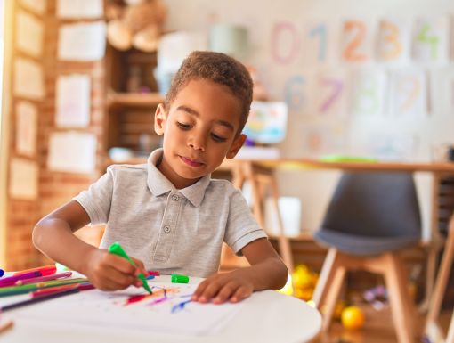 Boy drawing at table