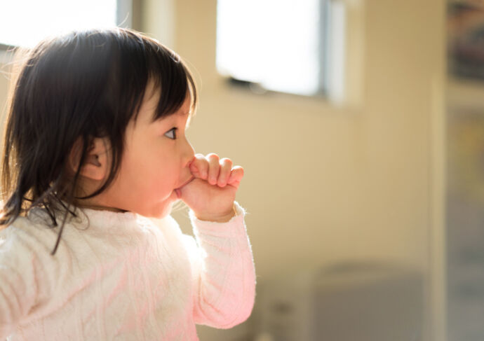 Little girl sucking her thumb