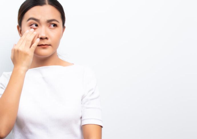 Woman touching her eye