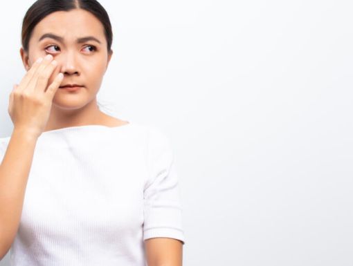 Woman touching her eye