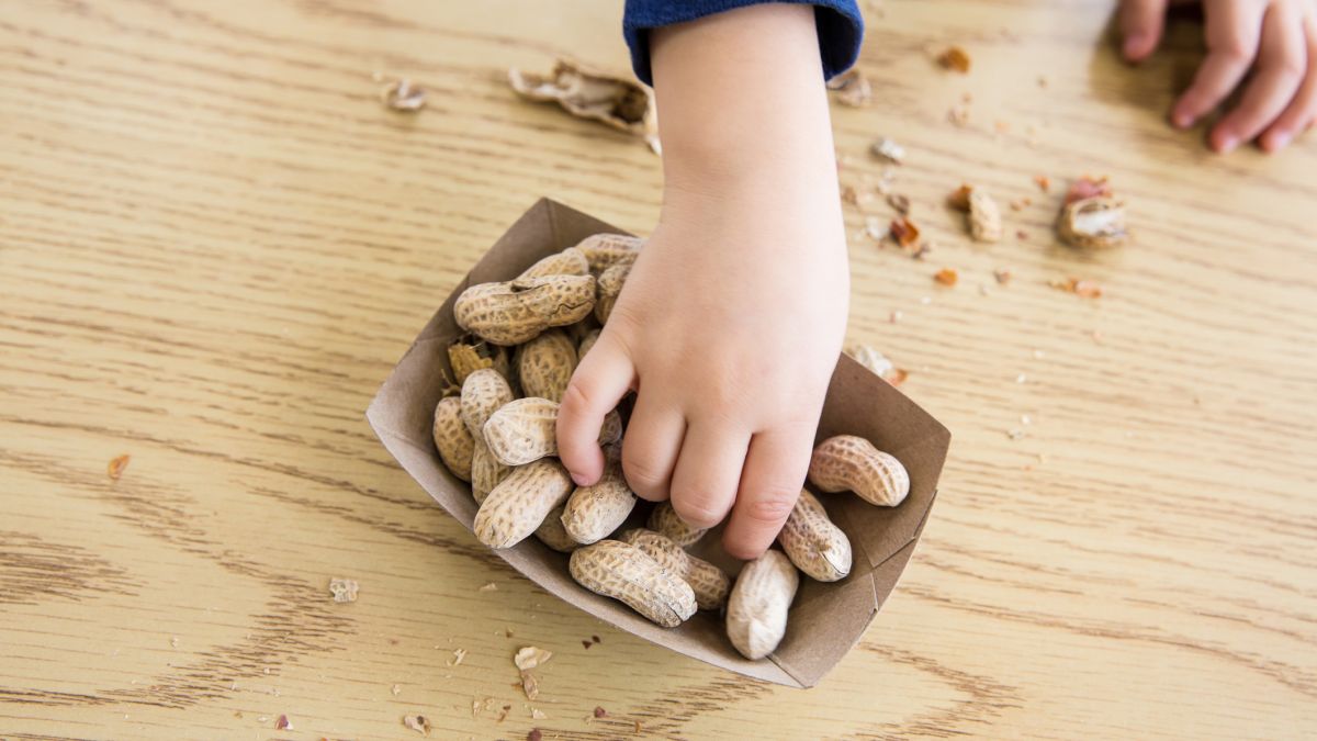 Child reaching for peanuts