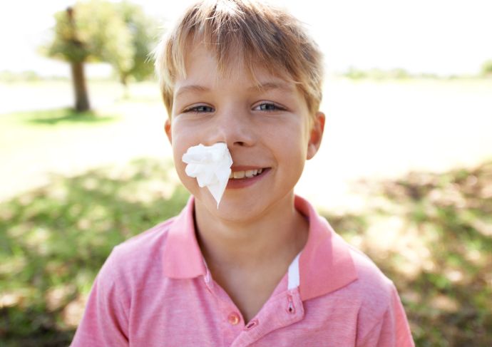Boy with tissue in nose