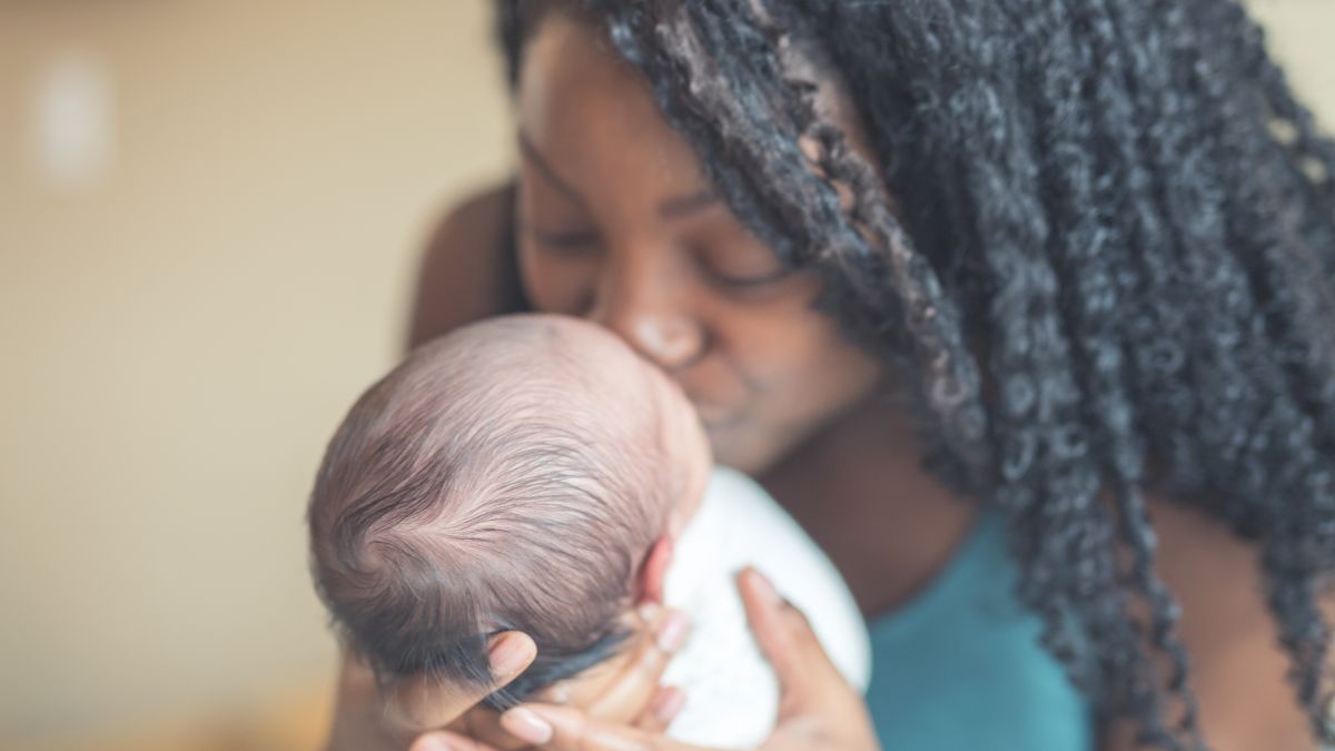 Mother kissing her baby
