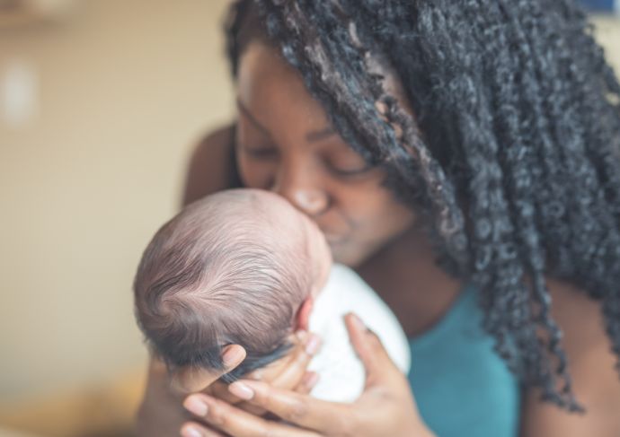 Mother kissing her baby