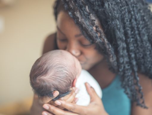 Mother kissing her baby