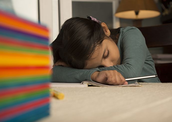 sleepy child with head on table