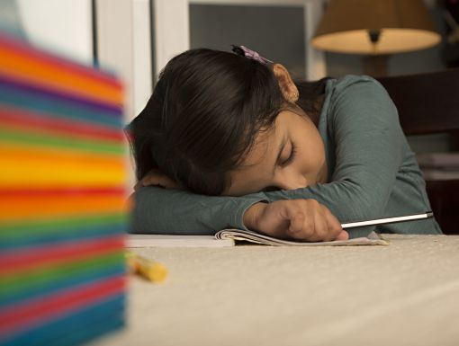sleepy child with head on table