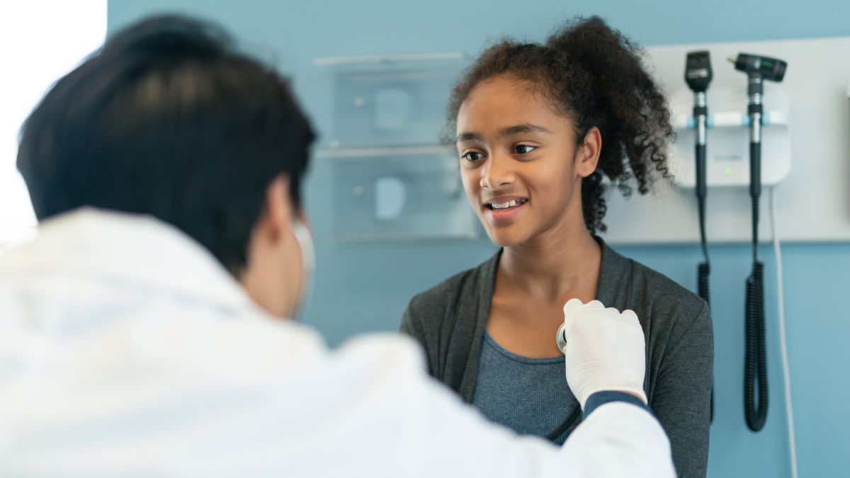 Doctor checking teen girls heart