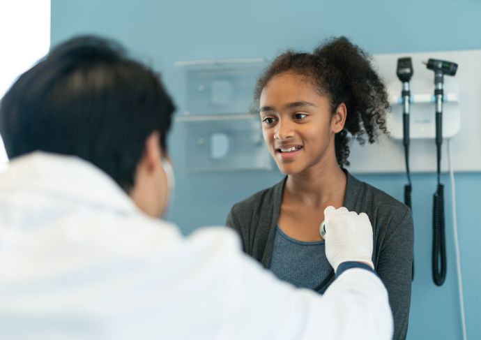 Doctor checking teen girls heart