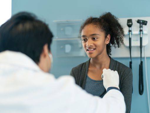 Doctor checking teen girls heart