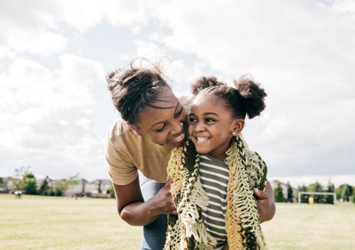 mom and daughter smiling and hugging