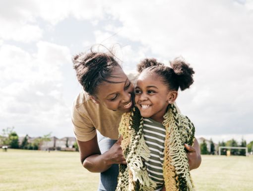 mom and daughter smiling and hugging