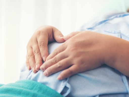 Woman with a heart on her pregnant belly