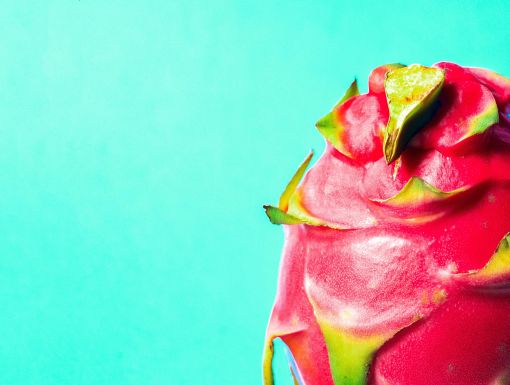 Red dragon fruit on teal background