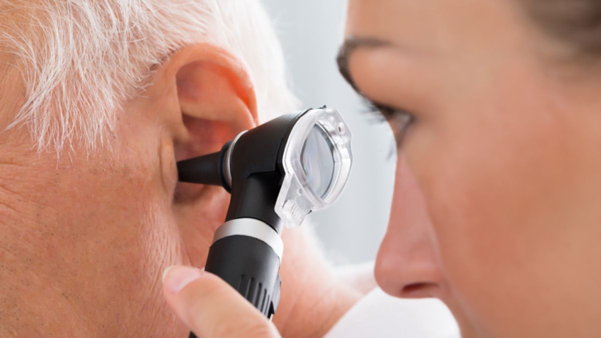 Doctor examining patient with earache