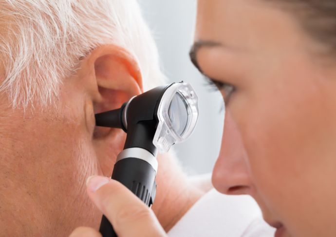 Doctor examining patient with earache
