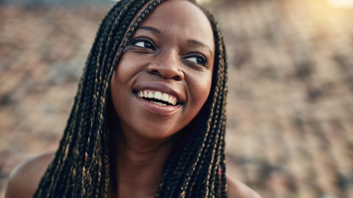 Woman smiling outside in the sunshine