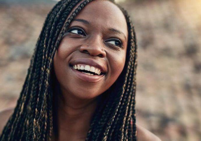 Woman smiling outside in the sunshine