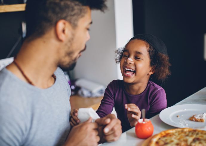 Father and son eating laughing