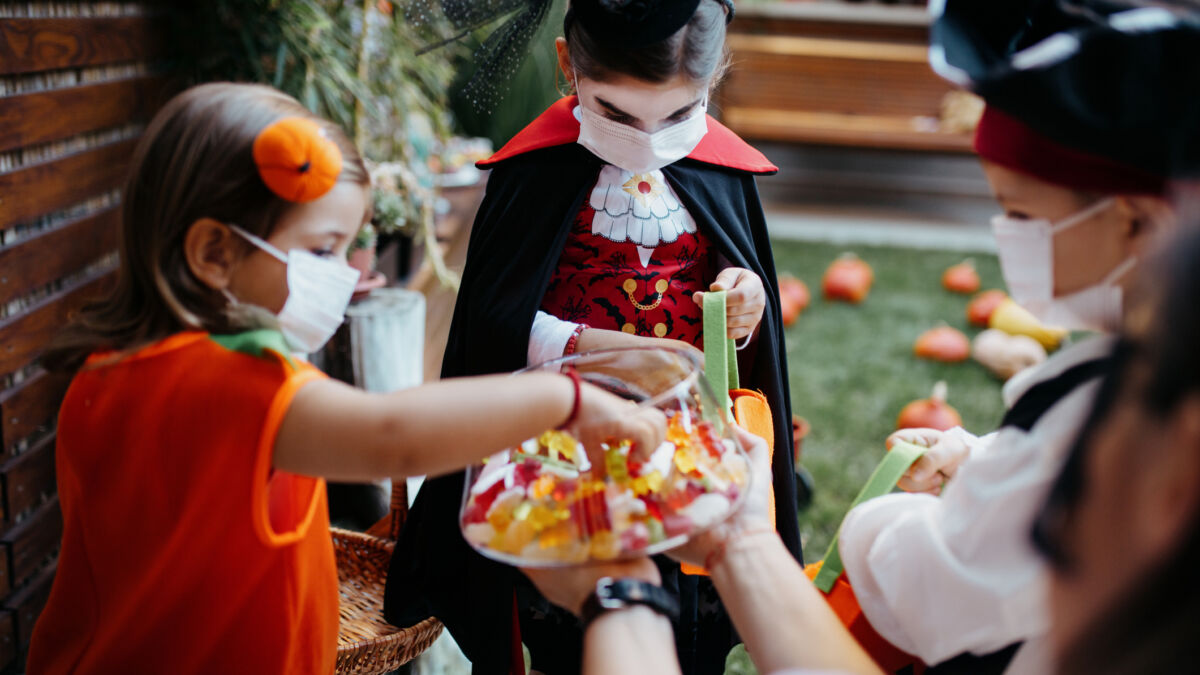 Trick or treaters in masks with healthy Halloween treat