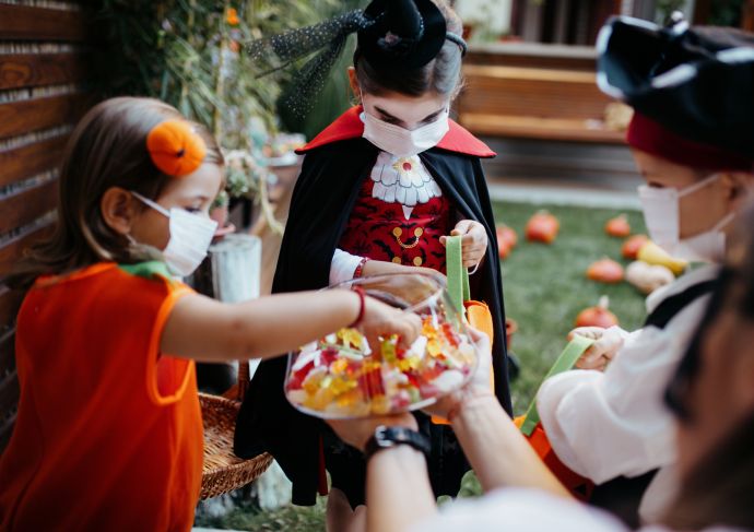 Trick or treaters in masks with healthy Halloween treat