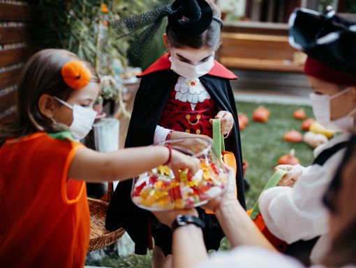 Trick or treaters in masks with healthy Halloween treat