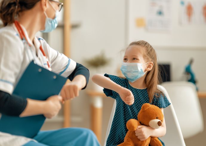 Kid and physician in masks