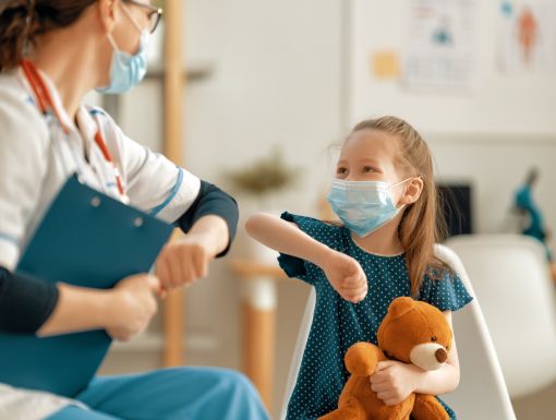 Kid and physician in masks