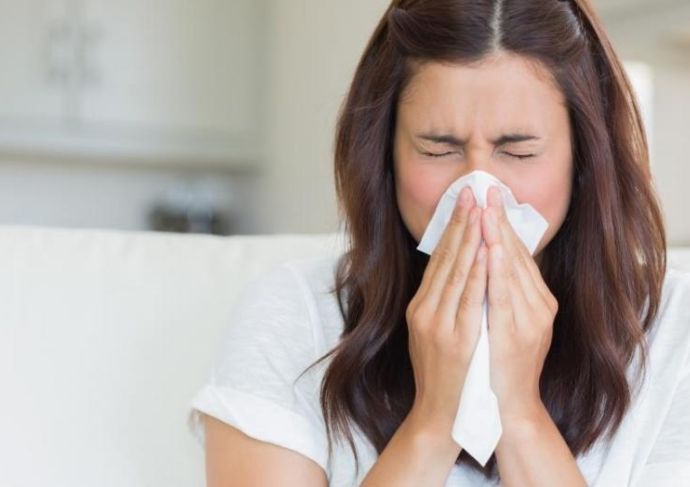 Woman blowing her nose