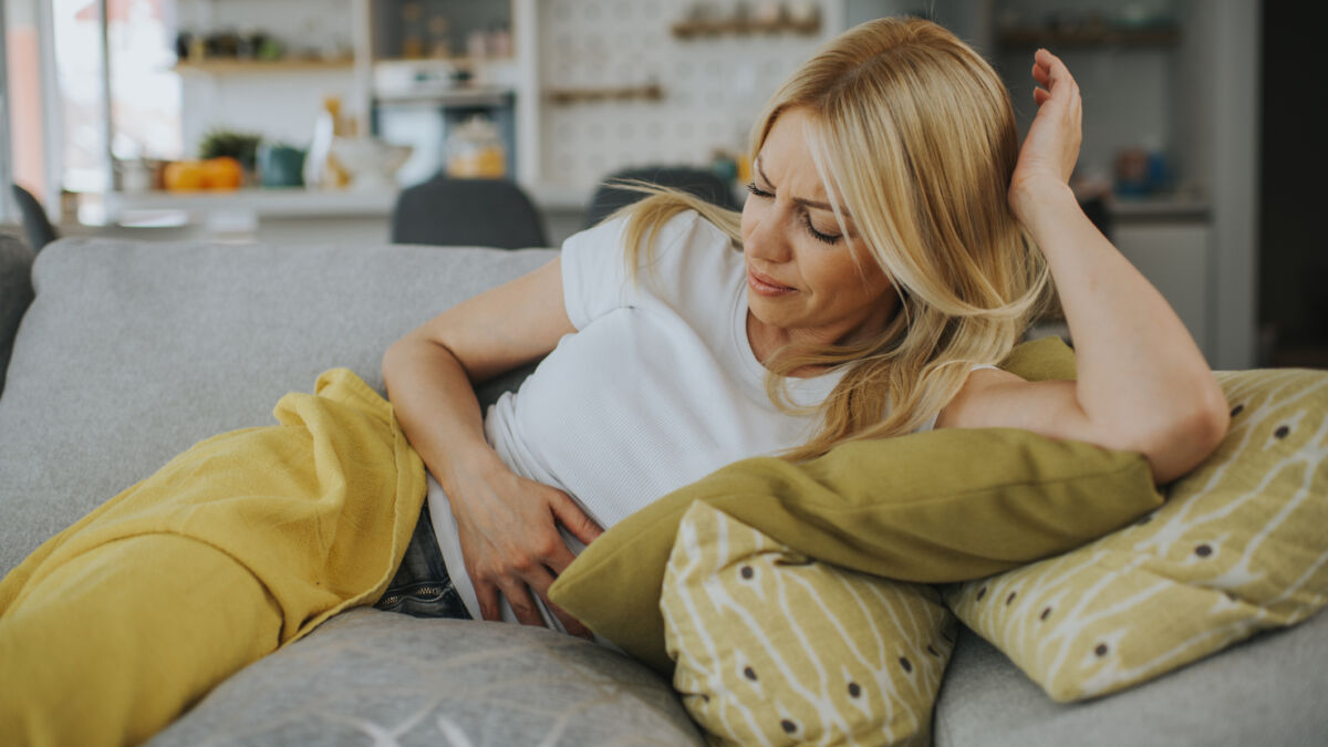 Upset stomach woman holding her stomach