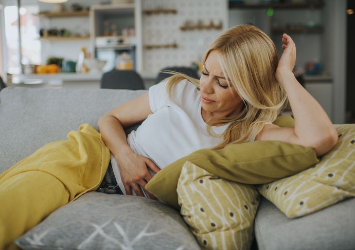 Upset stomach woman holding her stomach