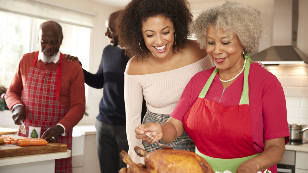 Family preparing turkey dinner together
