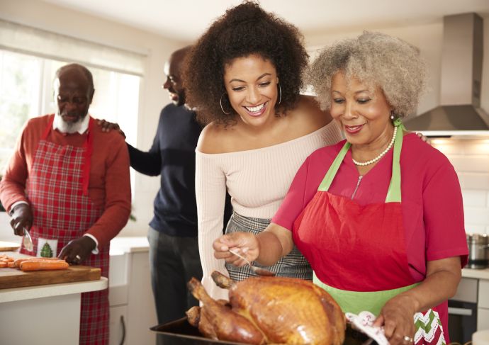 Family preparing turkey dinner together